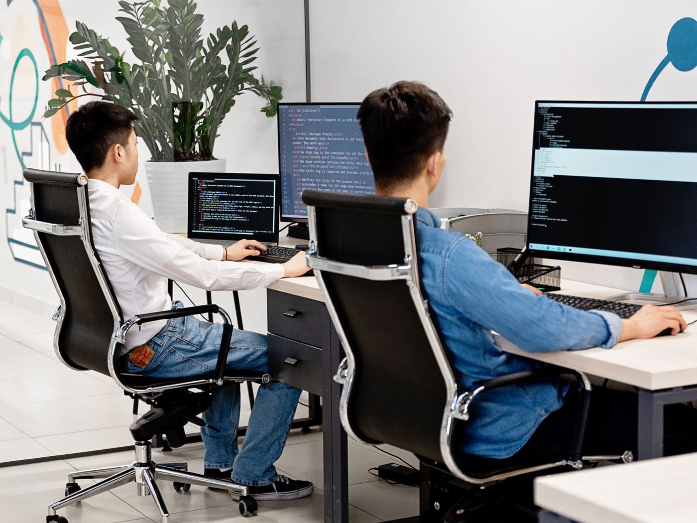 Software engineers modeling database architecture and multi-tenant cloud endpoints for custom SaaS platform